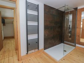 A bathroom with a shower and towel radiator at Old Post Office Cottage in Ulverston