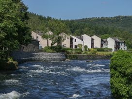 A view of houses along a river at Old Post Office Cottage in Ulverston