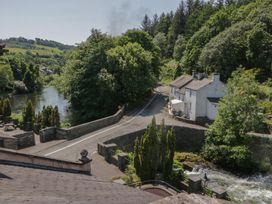 A view of a river and house near a road at Old Post Office Cottage Ulverston