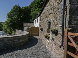 An outdoor path leading to a stone house at Old Post Office Cottage Backbarrow near Newby Bridge