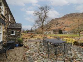 A patio area with a table and chairs at Deer How Farm Patterdale near Glenridding