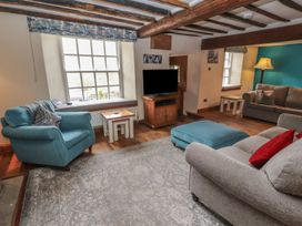 A living room with a television and seating area at Deer How Farm Patterdale near Glenridding