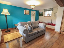 A living room with a sofa and coffee table at Deer How Farm in Patterdale near Glenridding