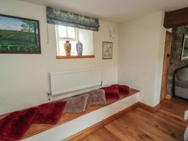 A snug with a radiator and cushions at Deer How Farm Patterdale near Glenridding