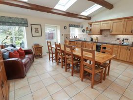 A kitchen with a dining table and chairs at Deer How Farm in Patterdale near Glenridding