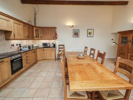 A kitchen with a dining table and chairs at Deer How Farm in Patterdale near Glenridding