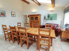 A dining room with a table and chairs at Deer How Farm near Patterdale