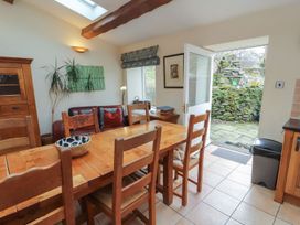 A dining room with a table and chairs at Deer How Farm in Patterdale near Glenridding