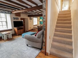 A living room with a sofa and television at Deer How Farm Patterdale near Glenridding