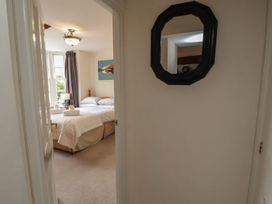 A bedroom with a bed and towels at Deer How Farm in Patterdale near Glenridding
