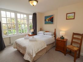 A bedroom with a bed and nightstand at Deer How Farm near Patterdale