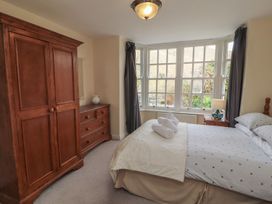 A bedroom with a bed and a wardrobe at Deer How Farm in Patterdale near Glenridding