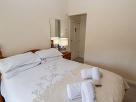 A bedroom with a bed and lamps at Deer How Farm Patterdale near Glenridding