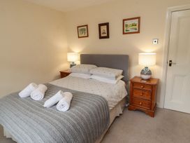 A bedroom with a bed and bedside tables at Deer How Farm in Patterdale near Glenridding