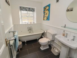A bathroom with bathtub, toilet and sink at Deer How Farm in Patterdale near Glenridding