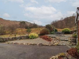 An outdoor area with stone path and patio furniture at Deer How Farm near Patterdale
