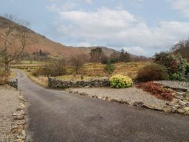 A view of a road and stone wall at Deer How Farm Patterdale near Glenridding