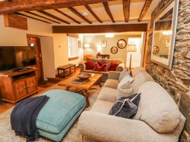 A living room with a sofa and television at Deer How Farm Patterdale near Glenridding