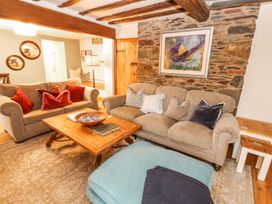 A living room with a sofa and coffee table at Deer How Farm in Patterdale near Glenridding
