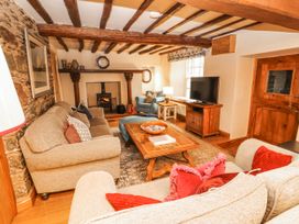 A living room with sofas and a television at Deer How Farm Patterdale near Glenridding