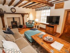 A living room with a sofa and armchair at Deer How Farm in Patterdale near Glenridding