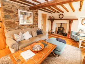 A living room with a sofa and fireplace at Deer How Farm Patterdale near Glenridding