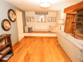 A snug with a sofa and decorative items at Deer How Farm Patterdale near Glenridding