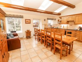 A kitchen with a table and chairs at Deer How Farm Patterdale near Glenridding
