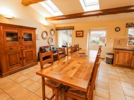 A dining room with a table and chairs at Deer How Farm Patterdale near Glenridding