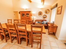 A dining room with a table and chairs at Deer How Farm in Patterdale near Glenridding