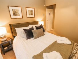 A bedroom with a bed and bedside table at Deer How Farm Patterdale near Glenridding