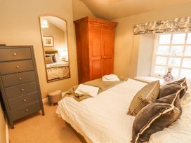 A bedroom with a bed and wardrobe at Deer How Farm Patterdale near Glenridding