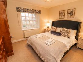 A bedroom with a bed and lamp at Deer How Farm in Patterdale near Glenridding