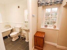 A bathroom with a bathtub, toilet, and sink at Deer How Farm, Patterdale near Glenridding
