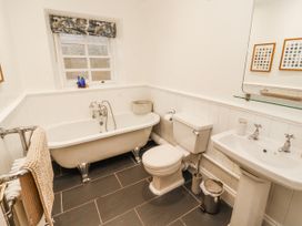 A bathroom with a bathtub, toilet, and sink at Deer How Farm in Patterdale near Glenridding