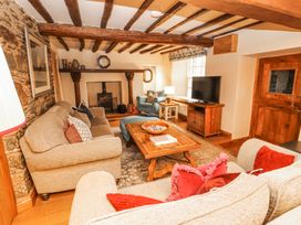 A living room with a coffee table and television at Deer How Farm, Patterdale near Glenridding