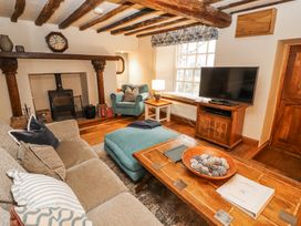 A living room with furniture and a television at Deer How Farm Patterdale near Glenridding