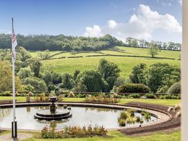A garden with a fountain and greenery at Harcombe House Accessible Pet Free Bungalow Sleeps 6 Chudleigh