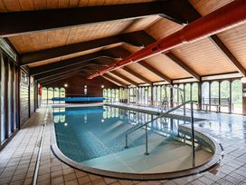 An indoor pool area with a swimming pool and views at Harcombe House Accessible Pet Free Bungalow Sleeps 6, Chudleigh