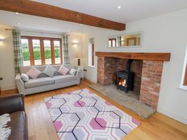 A living room with a fireplace and sofa at Filly Brook in Bishop's Frome