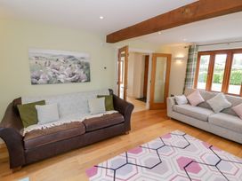 A living room with a sofa and rug at Filly Brook in Bishop's Frome
