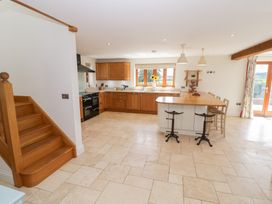A kitchen with wooden cabinets and a countertop at Filly Brook in Bishop's Frome