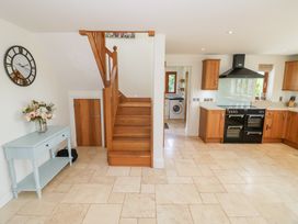 A kitchen with stairs and a console table at Filly Brook in Bishop's Frome