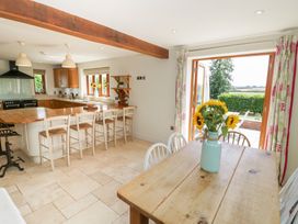 A kitchen with a dining table and chairs at Filly Brook in Bishop's Frome
