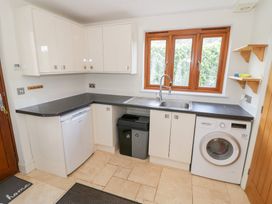 A kitchen with cabinets, sink, dishwasher and washing machine at Filly Brook in Bishop's Frome