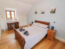 A bedroom with a bed and desk at Filly Brook in Bishop's Frome