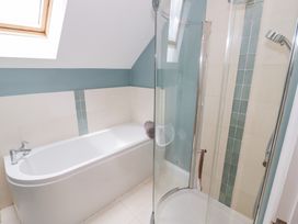 A bathroom with a bathtub and shower at Filly Brook in Bishop's Frome