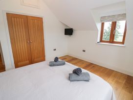 A bedroom with a bed and towels at Filly Brook in Bishop's Frome