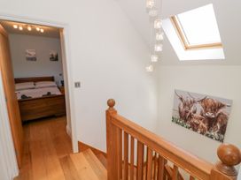 A staircase with a bedroom door and painting at Filly Brook in Bishop's Frome