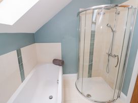 A bathroom with a bathtub and a shower at Filly Brook in Bishop's Frome